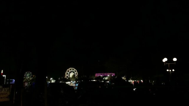 funfair or night carnival or dermulen in jawa timur indonesia with neon light on the ride
