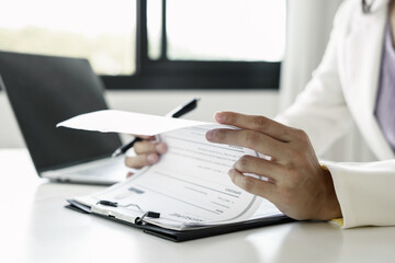 Fototapeta premium Business woman employer holding resume hiring recruit looking cv resume to hire candidates, analyzing information before job interview. Recruitment concepts