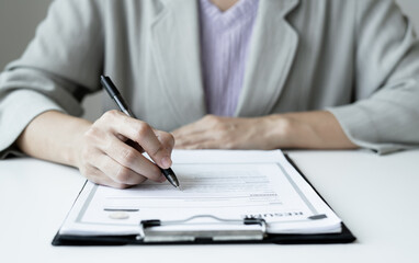 Fototapeta premium Business woman employer holding resume hiring recruit looking cv resume to hire candidates, analyzing information before job interview. Recruitment concepts