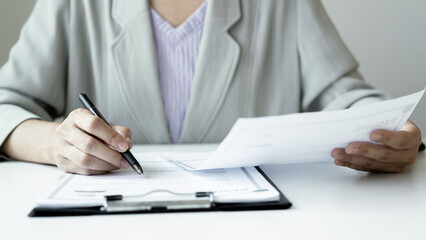 Business woman employer holding resume hiring recruit looking cv resume to hire candidates, analyzing information before job interview. Recruitment concepts