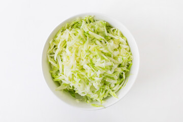 A bowl of freshly shredded white and green cabbage, perfect for healthy salads or coleslaw recipes, ideal for summer picnics