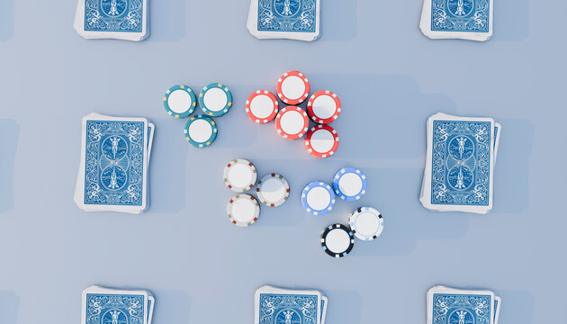 Poker chips amidst playing cards on blue background