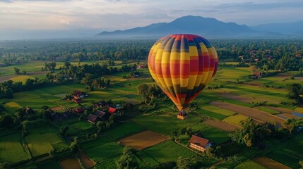 Fototapeta premium A scenic hot air balloon ride over Chiang Mai countryside, with stunning views of rice fields and temples.