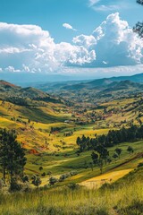 Lush green valley with rolling hills and clouds under a bright blue sky in the afternoon