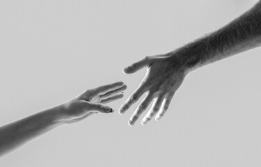 Helping hand concept, support. Two hands, shaking hands. Black and white