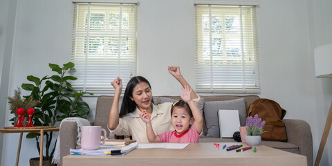 Joyful Mother and Daughter Celebrating Art Time at Home