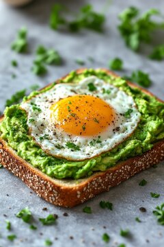 Avocado toast with fried eggs and cherry tomatoes on marble table