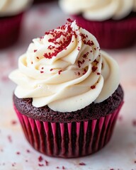 A delicious red velvet cupcake topped with creamy frosting and red sprinkles.