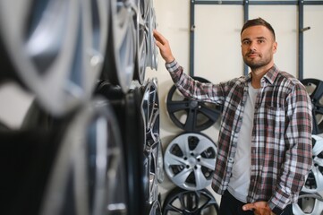 A male customer in a car rim shop
