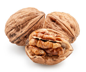 Whole walnuts, broken walnut with kernel and green leaves isolated on white background. Clipping path.