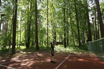 Badminton player, outdoor activity in a park with shuttlecock and racket, summer sport and leisure game.