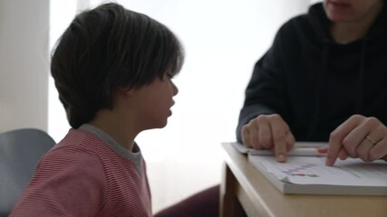 Frustrated child persevering through an educational activity with a parent, emphasizing determination and the supportive role of parental involvement in a home learning environment