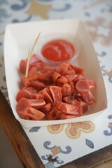 Chicken sausage with tomato and sauce.