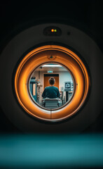 View through the circular opening of a modern CT scan machine in a medical setting, capturing the advanced technology used in diagnostics and patient care.