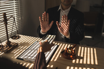 Lawyer, businessman or accountant is refusing money and resisting the partner's bribery agreement to settle a joint debt. Kickback, bribe money. Anti-illegal bribery concept at the desk in the office.