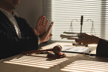 Lawyer, businessman or accountant is refusing money and resisting the partner's bribery agreement...