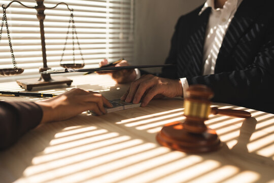 Lawyer, businessman or accountant is refusing money and resisting the partner's bribery agreement to settle a joint debt. Kickback, bribe money. Anti-illegal bribery concept at the desk in the office.