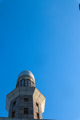 Obraz premium A close-up photo of a mosque minaret against a clear blue sky, Islamic Concept, Religious