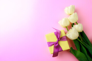 Gift box and spring flowers on pink background. Stylish soft image of spring flowers. Happy womens day. Happy Mothers day.Hello Spring- Image