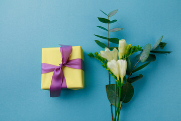 Gift box and spring flowers on color background. Stylish soft image of spring flowers. Happy womens day. Happy Mothers day.Hello Spring- Image