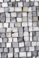 Surface covered with grey and white stone mosaic