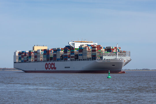 Stade, Germany &ndash; May 1, 2023: Container ship OOCL Spain on Elbe river heading to Hamburg. OOCL's fleet is based in Hongkong .