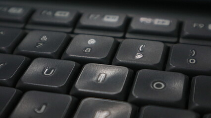 A close up photo of a grey and white office computer keyboard.