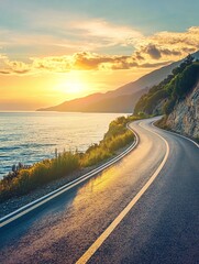 A winding road along a scenic coastline with a vibrant sunset in the background.