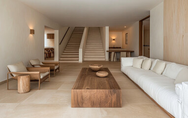 Modern minimalist living room design featuring natural wood furniture and a bright open space in a contemporary home setting