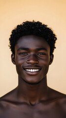Fototapeta premium A front portrait of a young African man, smiling, centered, short curly black hair, dark brown skin, plain beige background