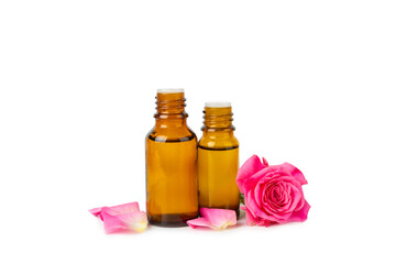Rose essential oil isolated on white background.Roses and a bottle of rose perfumed water. Aromatherapy treatment. Beauty concept. Spa procedure.Natural organic oil.Anti-stress and detox relax.