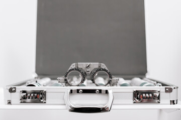 A vision measuring instrument with a trial frame used by optometrists for vision testing and...