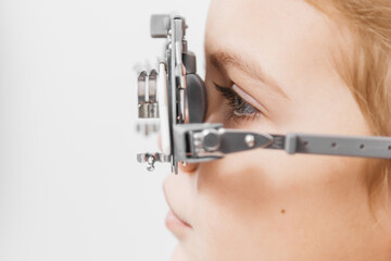 A doctor diagnosing a little girl’s vision and selecting lenses using a modern medical device. Perfect for illustrating diagnostics and vision correction.