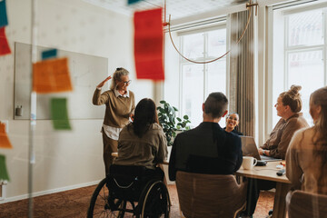 Happy female business professional explaining ideas to colleagues in meeting room