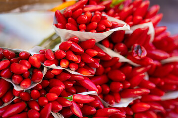Abstract view of chilies on sale at the Rialto Market in Venice. Close-up of a large bunch of fresh red chili peppers at a market stall in Venice. 