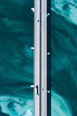 Aerial drone view of asphalt road bridge with cars and truck over turquoise blue water river sea ocean. Amazing summer landscape.