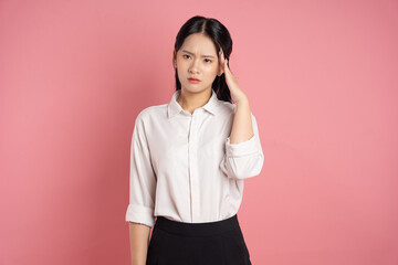 portrait of Asian business woman posing on pink background