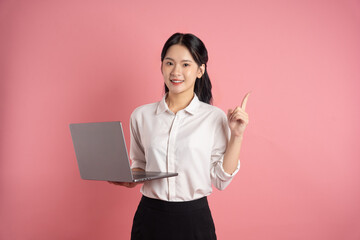 portrait of Asian business woman posing on pink background