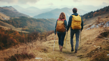 Obraz premium Loving mid aged couple with a backapacks hiking on the hills together 