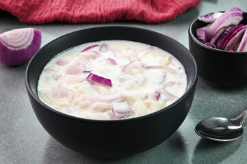 Onion raita served in a bowl.