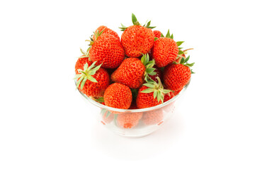 Ripe garden strawberries in a glass vase.