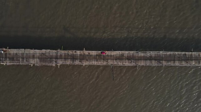 Aerial footage shows a wooden bridge spanning the Progo River, passable by motorbikes. As a link between the villages of Bantul and Kulonprogo.