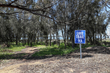Walking, hiking, trail, footpath, with sign, in the native bush land vegetation, next to Lake Yealering, an ephemeral salt lake in the Wheatbelt region of Western Australia
