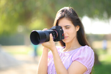 Serious photographer taking pictures in a park