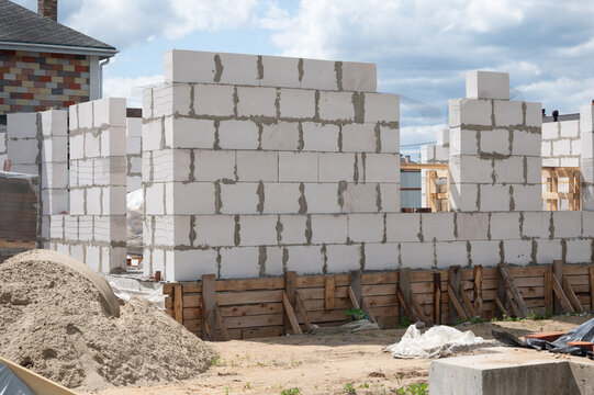 Building walls with aerated concrete blocks on construction site