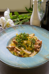 mediterranean pasta with mushrooms, sun-dried tomatoes, garlic and deep-fried rocket salad