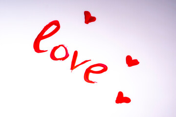 the word love written with red acrylic paint.Heart. love