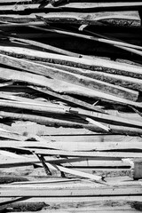 Black and White Close-up of a pile of wood in the mountains of southern Tyrol