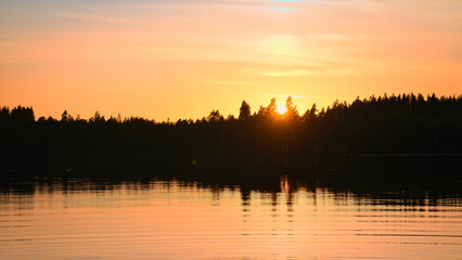 Sunset with warm colors on a Swedish lake in Smalland. Romantic evening atmosphere