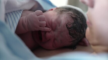 First minutes of a newborn baby coming to the world, first cries and moments of infant child arrival resting on mother's chest emphasizing maternal care - Powered by Adobe